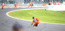 Marshals clear rubber from the track after another blowout