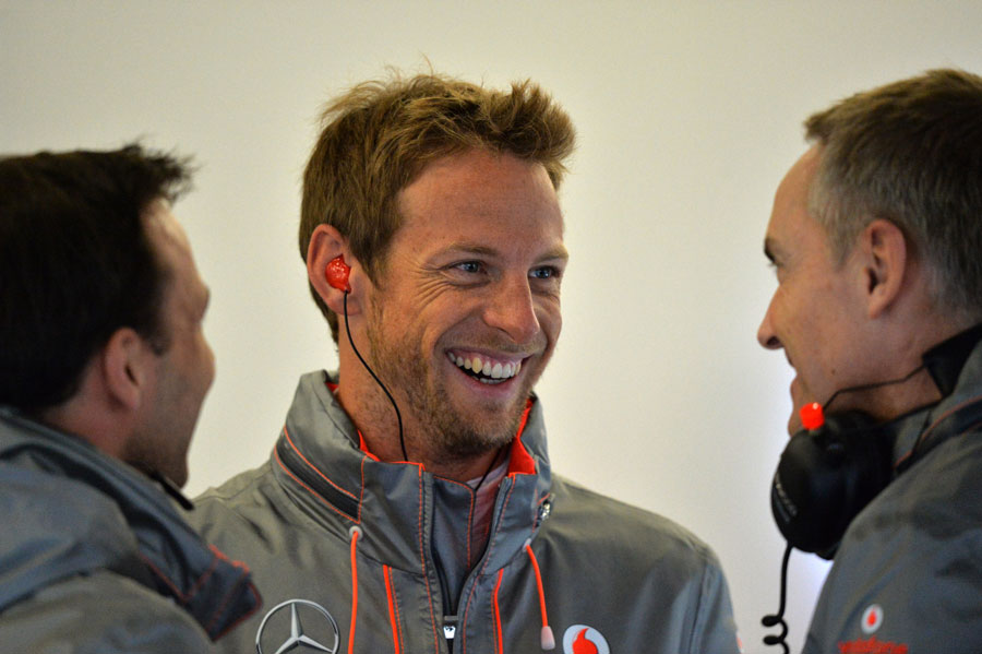 Jenson Button jokes with Martin Whitmarsh in the pits