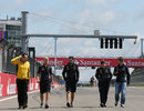 Sebastian Vettel walks the track with his engineers 