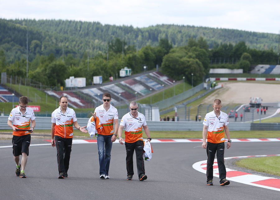 Paul di Resta walks the track with his engineers 