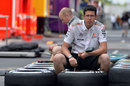 McLaren engineers check tyre pressures in the paddock