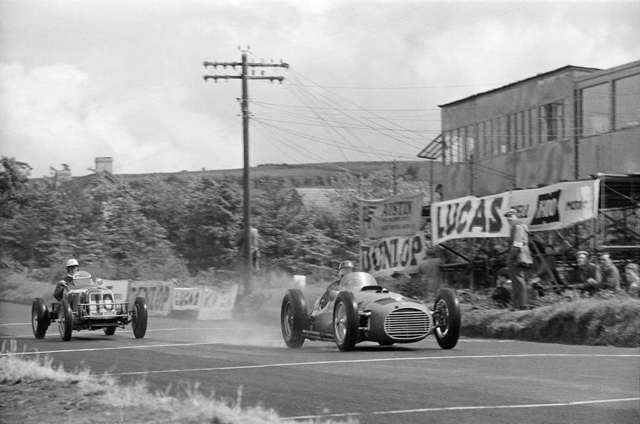 Juan Manuel Fangio roars past the ERA driven by Ron Flockhart. Both cars failed to finish