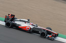 Jenson Button uses all the kerb on the exit