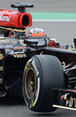 Kimi Raikkonen lifts a wheel in his Lotus