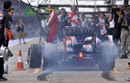 Sebastian Vettel lays down rubber in his pit box