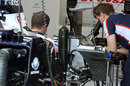 Williams mechanics work on Pastor Maldonado's car after a KERS failure