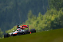 Jenson Button crests a hill in his McLaren