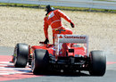 Felipe Massa climbs out of his stricken Ferrari