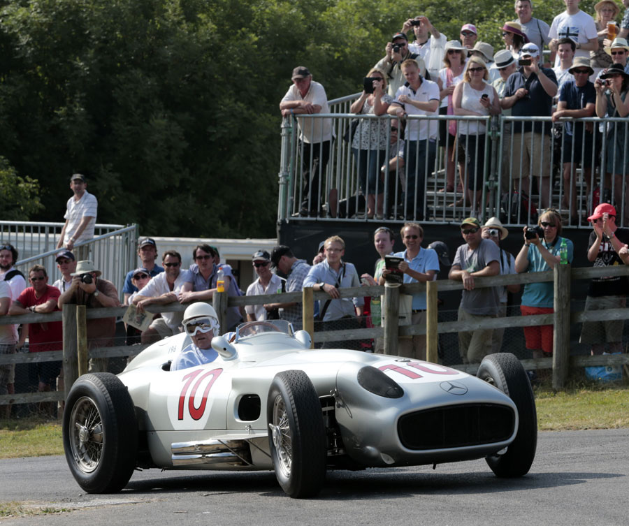 Sir Stirling Moss arrives at the top of the hillcimb in a Mercedes W196