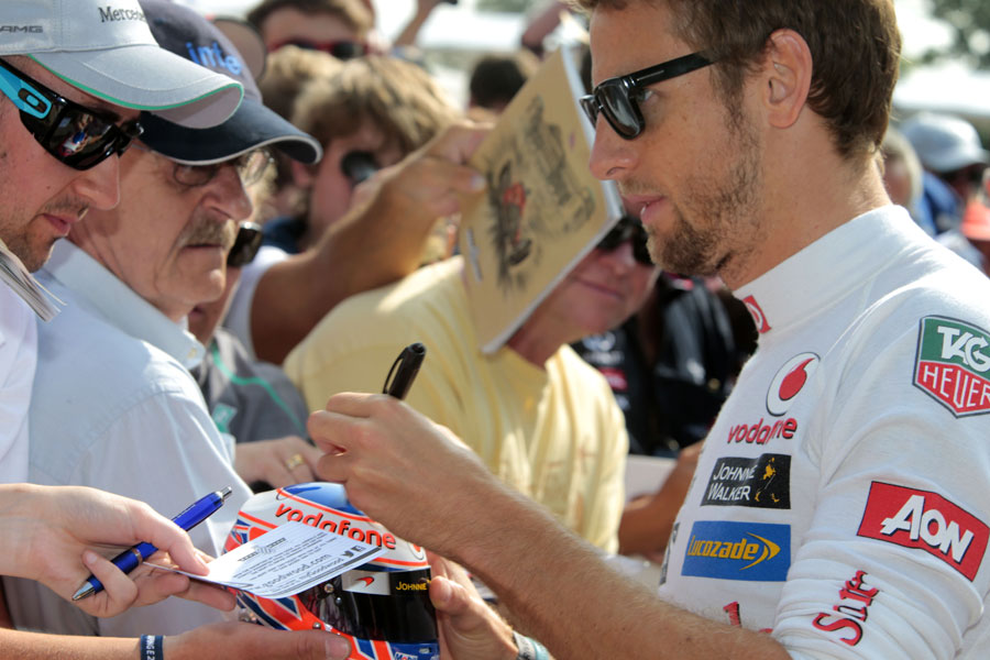 Jenson Button signs autographs