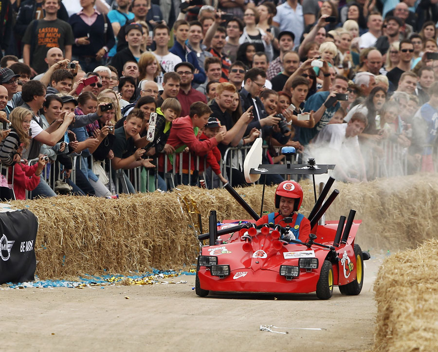 Sebastian Vettel takes part in a soapbox derby event dressed as Super Mario