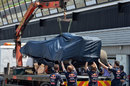 The Red Bull RB9 is returned to the pits after Daniel Ricciardo went off
