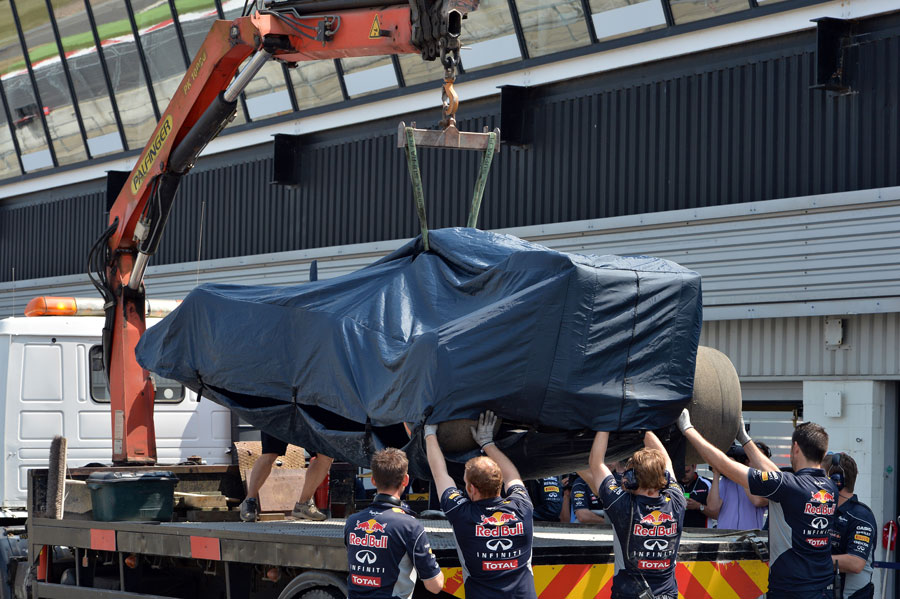 The Red Bull RB9 is returned to the pits after Daniel Ricciardo went off
