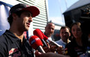 Daniel Ricciardo talks to TV crews in the paddock