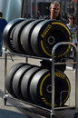 A Lotus mechanic returns Pirelli tyres in the paddock