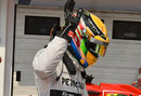 Lewis Hamilton waves to the crowd after taking pole