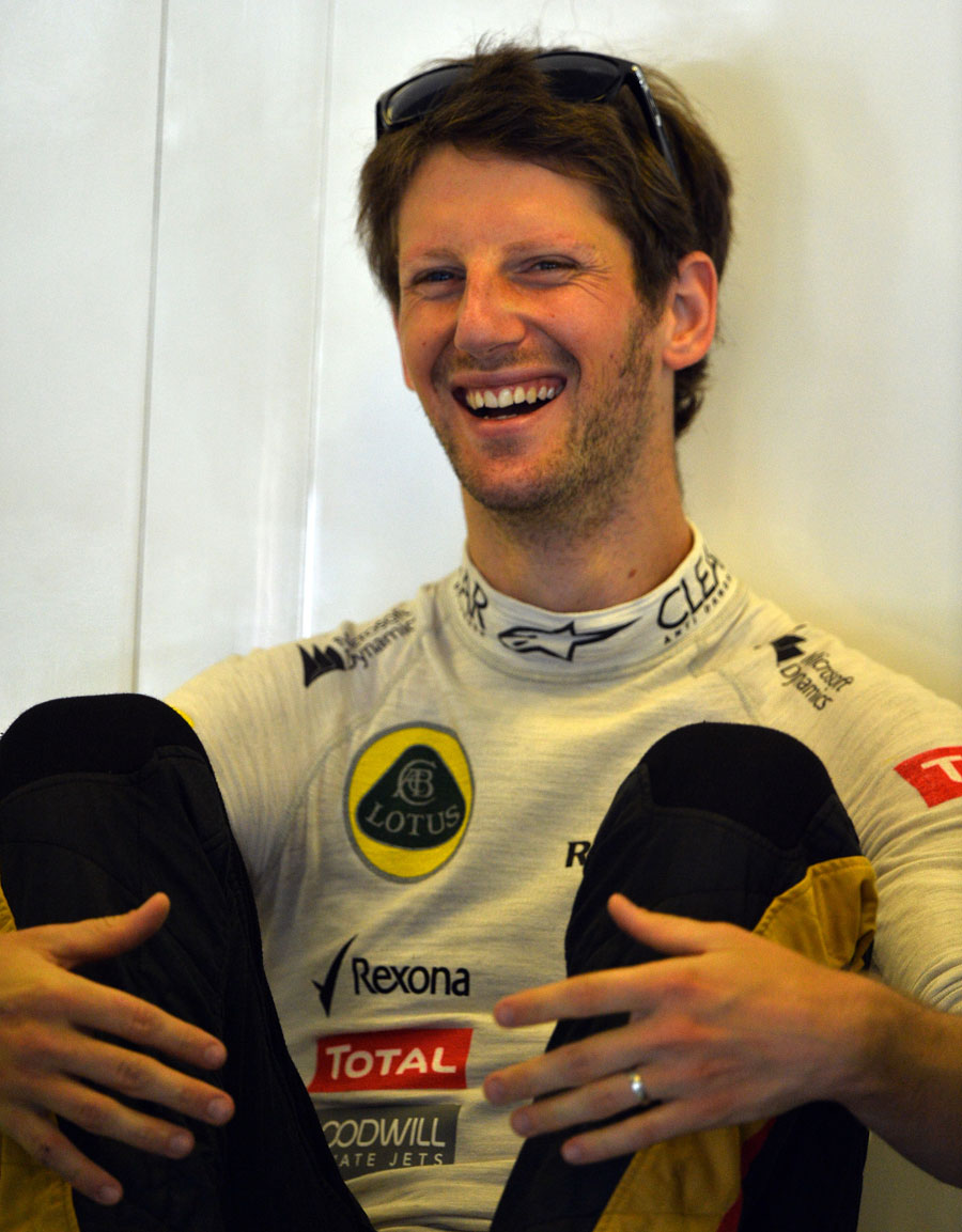 Romain Grosjean enjoys a joke in the Lotus garage
