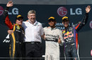 Lewis Hamilton celebrates alongside Ross Brawn, Kimi Raikkonen and Sebastian Vettel on the podium
