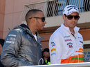 Lewis Hamilton talks with Adrian Sutil on the way to the drivers' parade