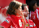 A Ferrari crew member, emblazoned in Marlboro emblems enjoys a cigarette