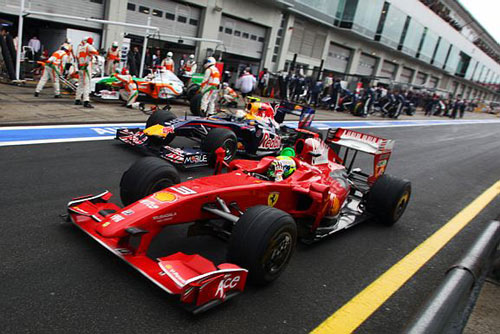 Massa and Vettel jockey for position in the pit lane