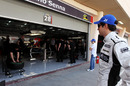 Bruno Senna looks nervously into the HRT garage