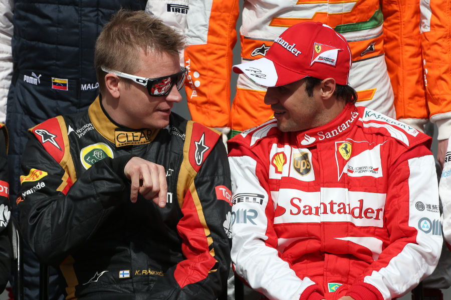Kimi Raikkonen chats to Felipe Massa during the traditional pre-season group shot
