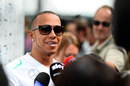 Lewis Hamilton talks to TV crews outside the Mercedes motorhome