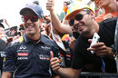 Sebastian Vettel poses with fans during an autograph session