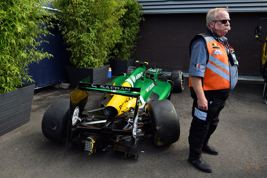 Giedo van der Garde's wrecked Caterham is watched over by a security guard
