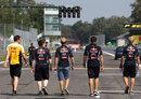 Sebastian Vettel walks the track with his Red Bull engineers