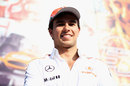 Sergio Perez is all smiles in front of the McLaren motorhome