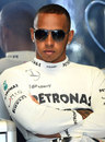 Lewis Hamilton keeps an eye on his car in the Mercedes garage