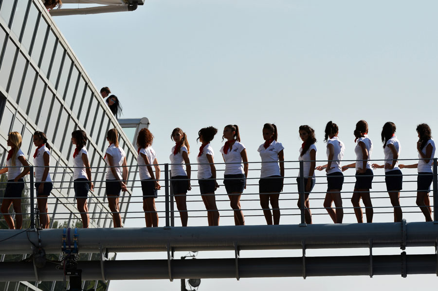 Grid girls line up by the podium