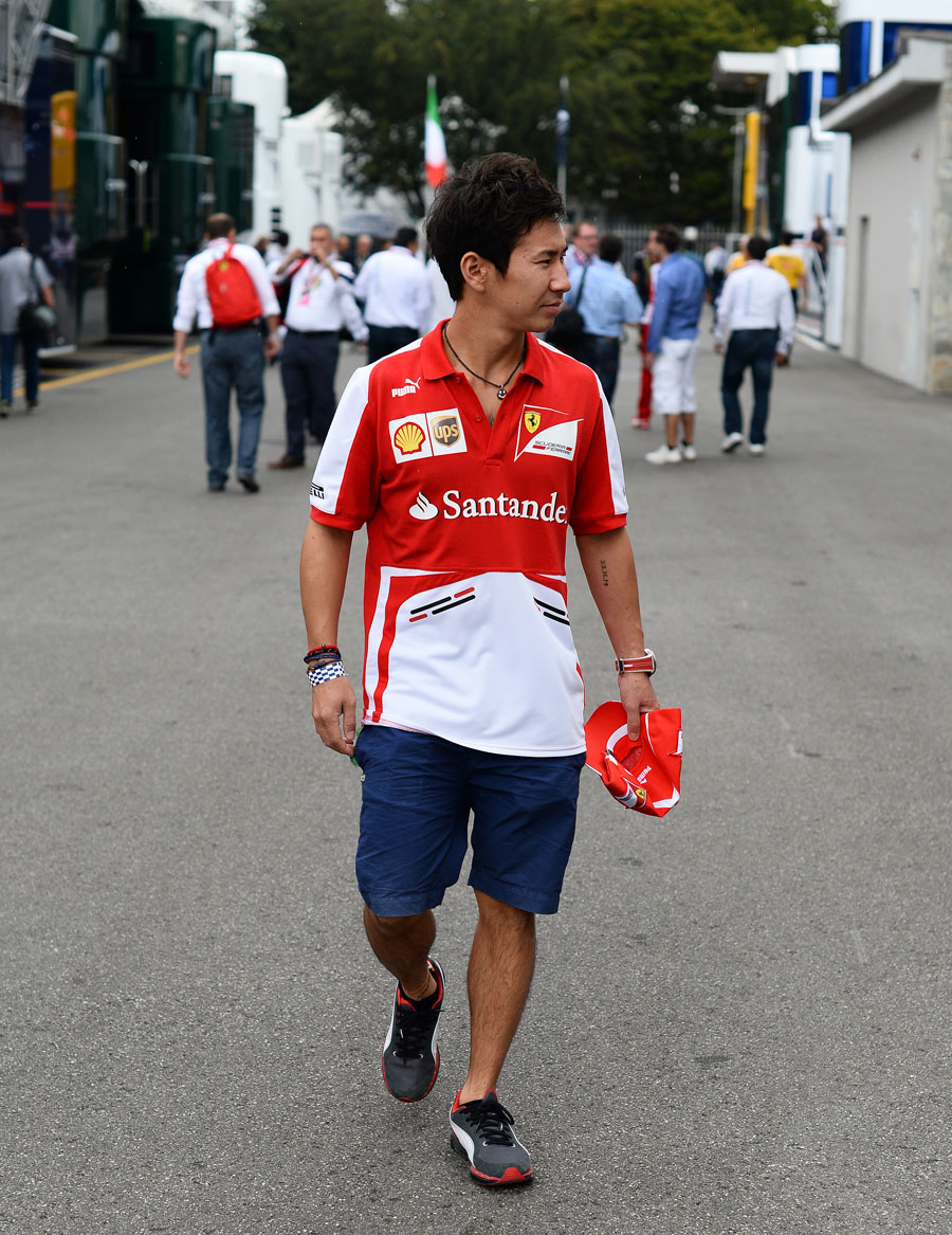 Kamui Kobayashi walks through the paddock