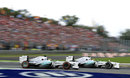 Lewis Hamilton passes team-mate Nico Rosberg at the first chicane