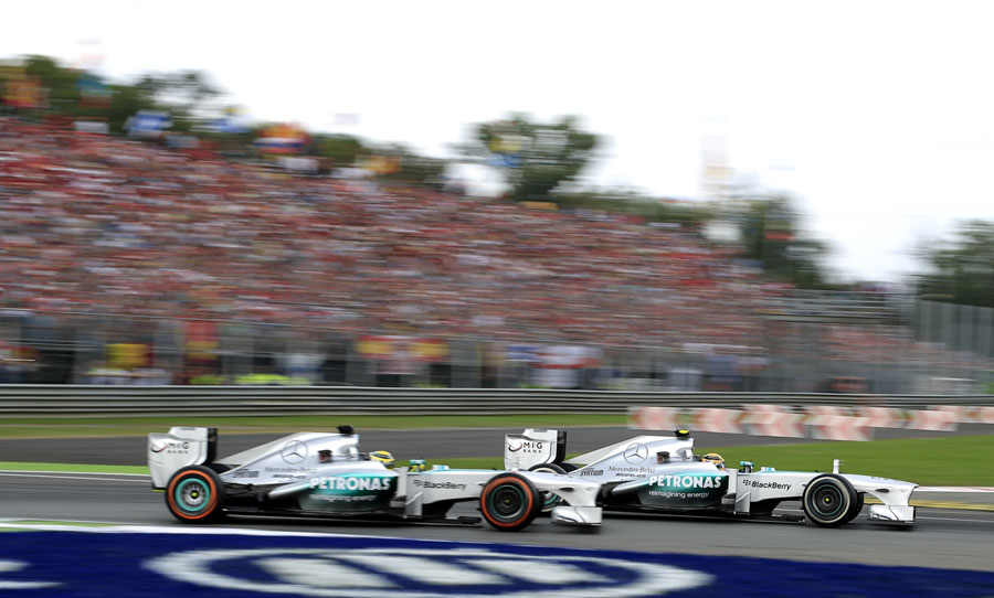 Lewis Hamilton passes team-mate Nico Rosberg at the first chicane