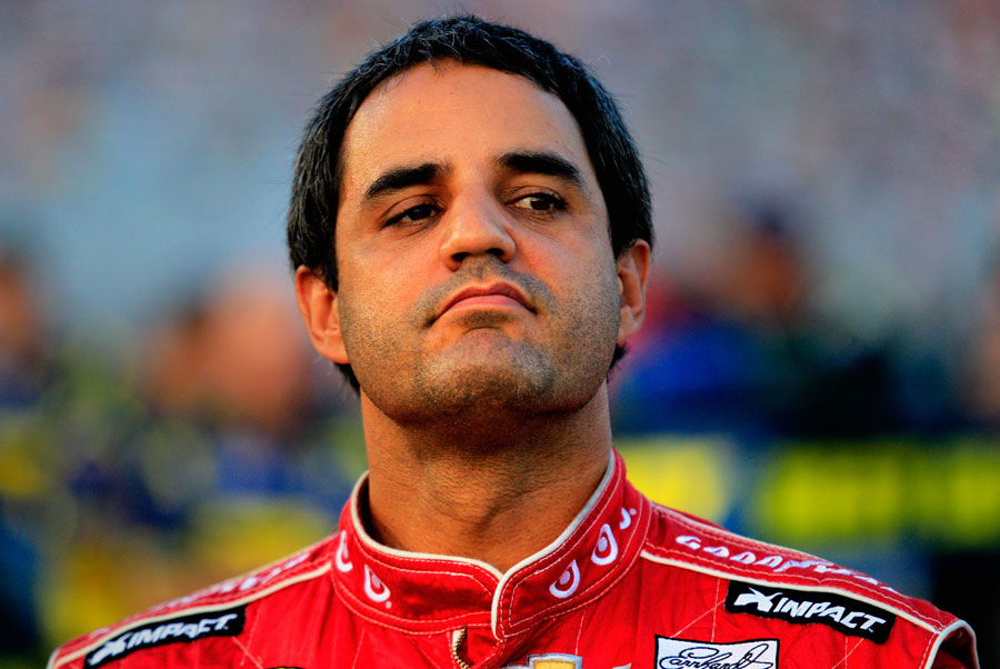 Juan Pablo Montoya stands in the pits during qualifying