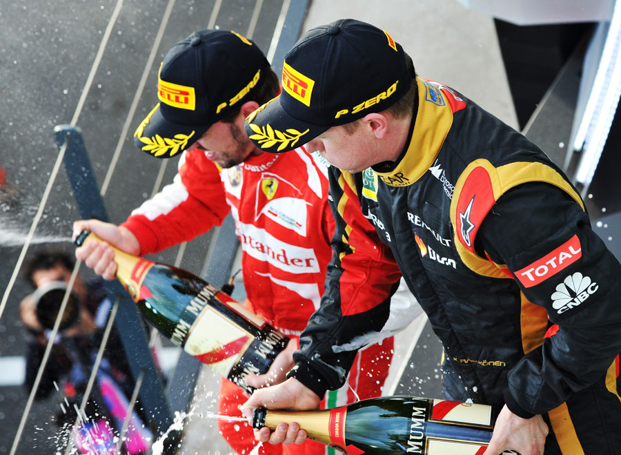 Kimi Raikkonen and Fernando Alonso celebrate on the podium