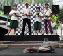 Jenson Button races remote control cars with school children in Singapore