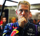 Sebastian Vettel watches on in the Red Bull garage after opting not to go for a final run in Q3