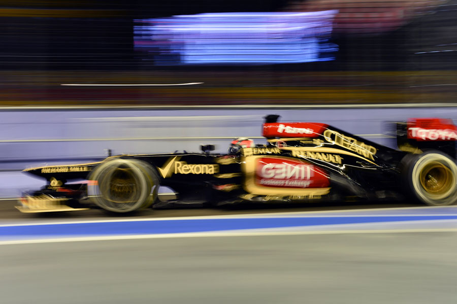 Kimi Raikkonen at speed in the pit lane