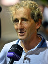 Alain Prost talks to media in the paddock
