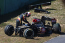 Kimi Raikkonen climbs out of his heavily-damaged Lotus after crashing at the end of FP1