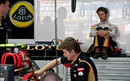 Romain Grosjean watches on as work takes place on his Lotus