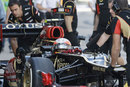 Romain Grosjean is wheeled back in to the Lotus garage