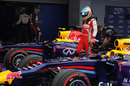 Fernando Alonso walks between the two Red Bulls in parc ferme