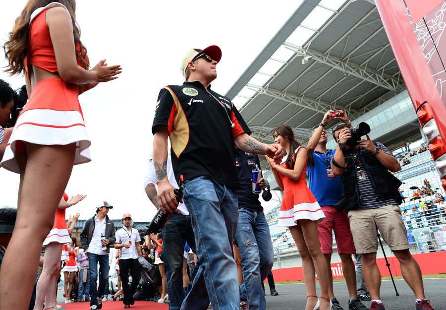 Kimi Raikkonen makes his way to the drivers' parade