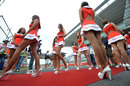 Grid girls head to the grid for the start of the race