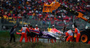 Mark Webber's Red Bull is lifted away after catching fire